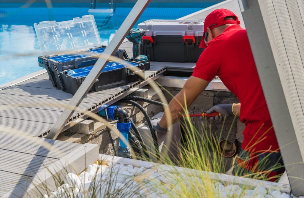 technician fixing swimming pool heating system 2023 11 27 04 58 22 utc